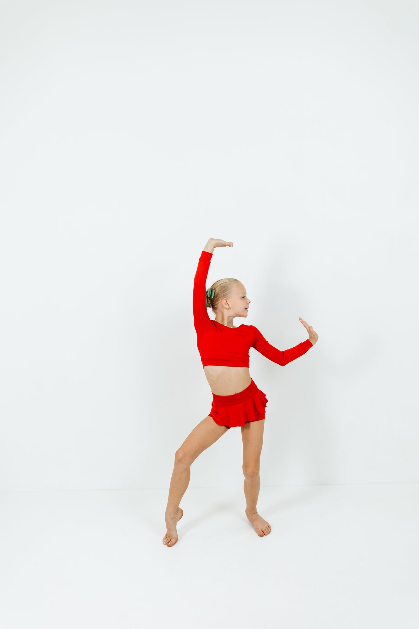 girl wearing red long sleeve top and skirt dance set