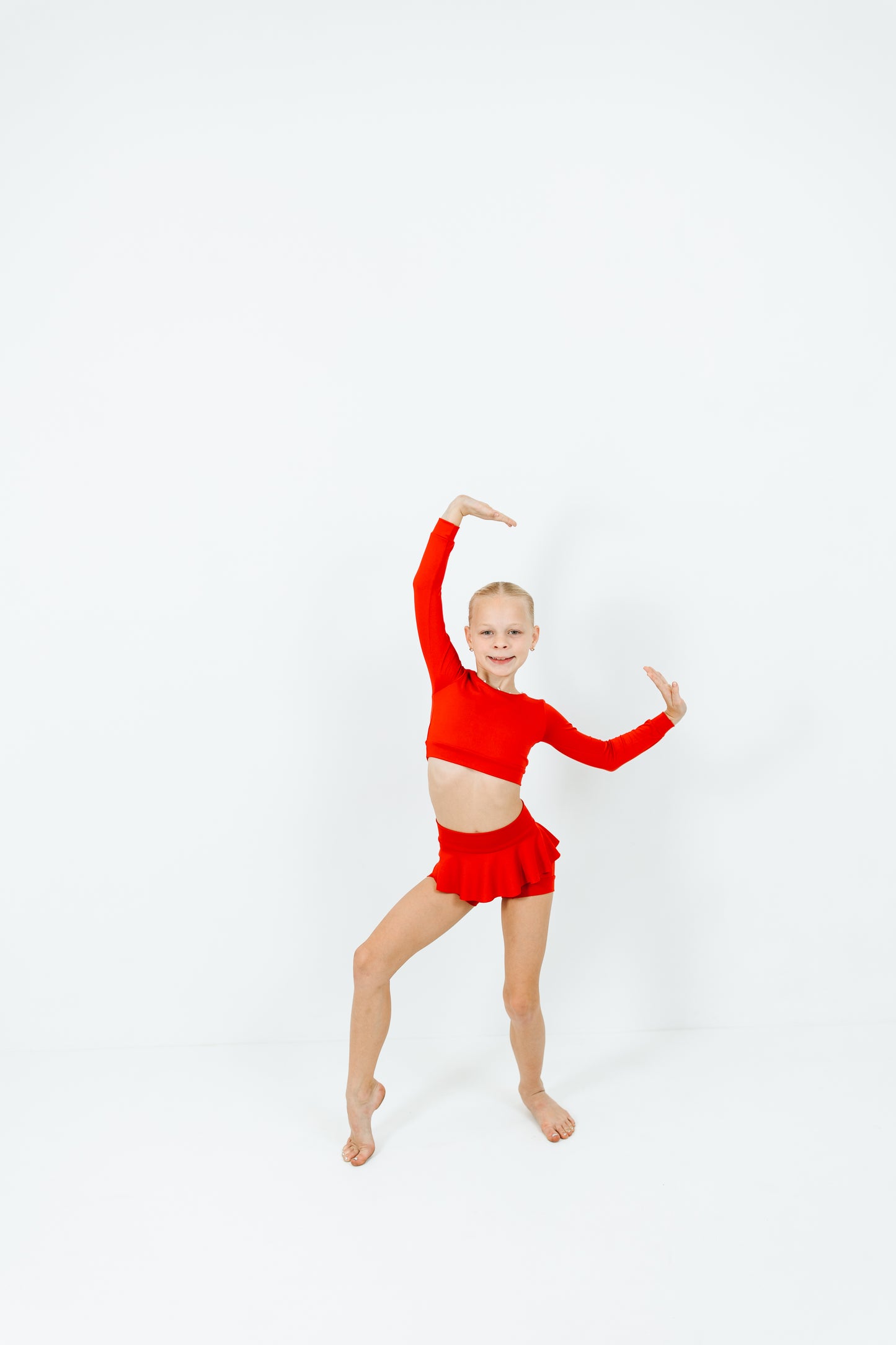 girl wearing red long sleeve top and skirt dance set