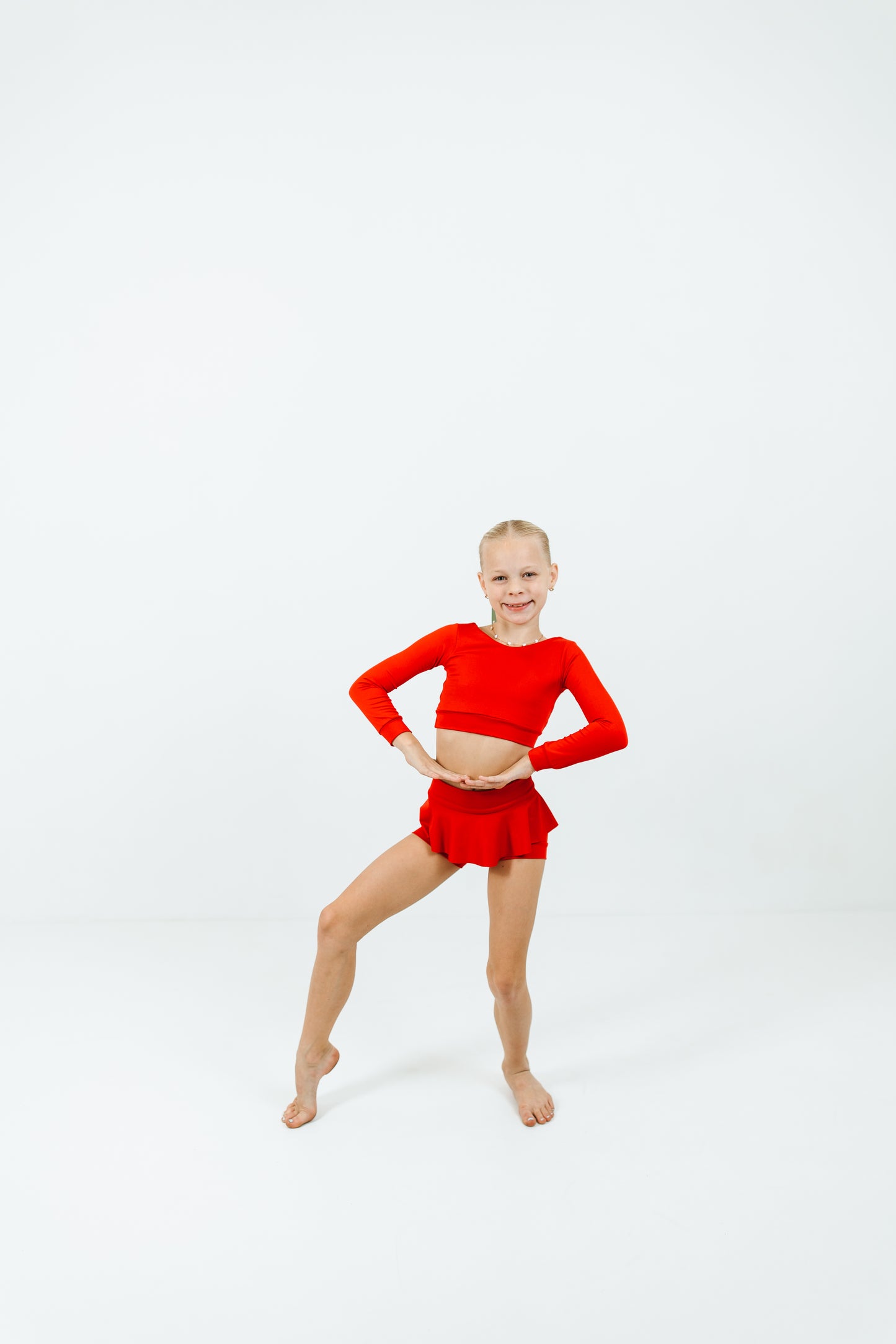 girl wearing red long sleeve top and skirt dance set