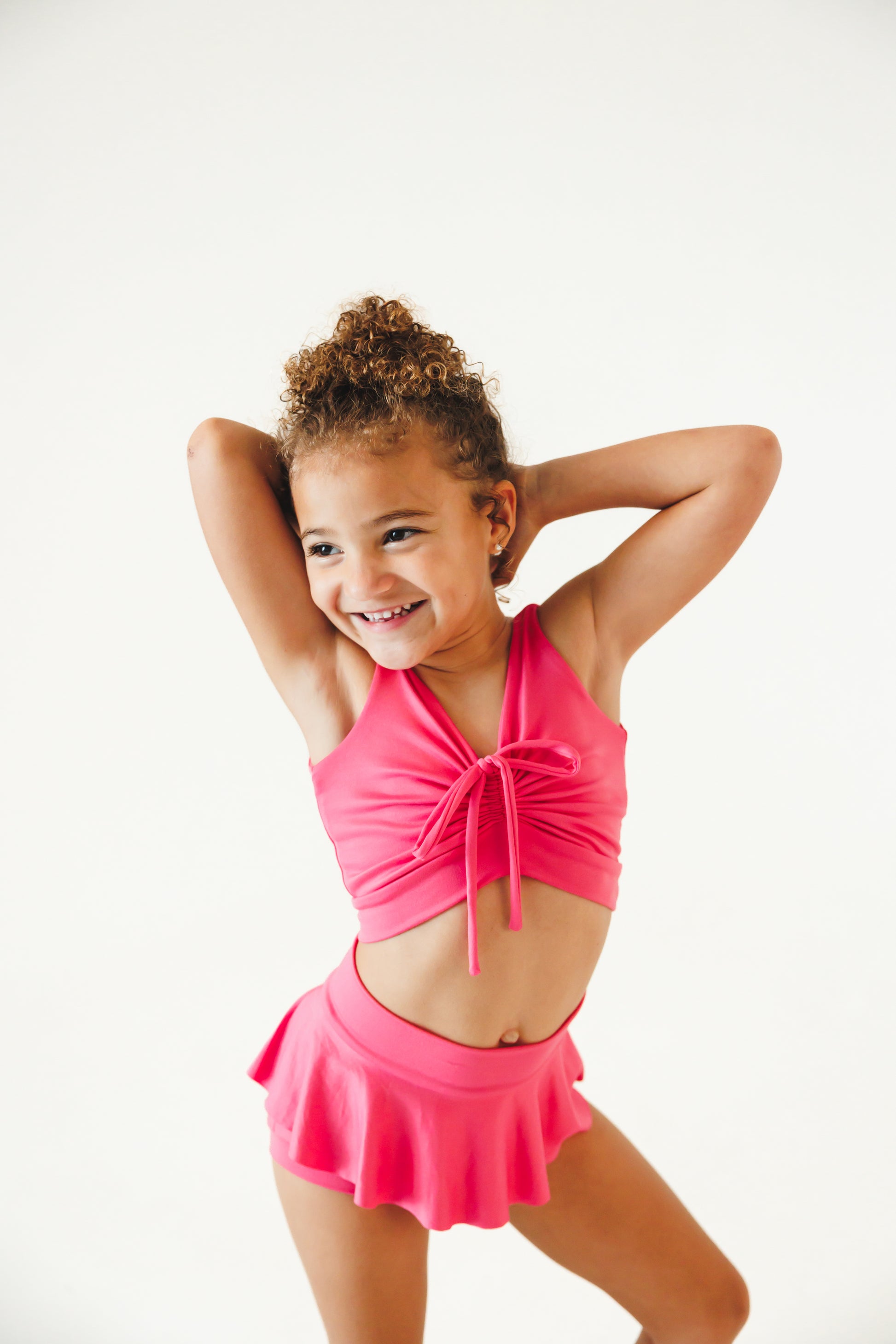 girl wearing hot pink dance set with skirt and cinched top